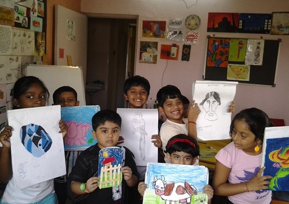 Group picture of kids with their artworks
